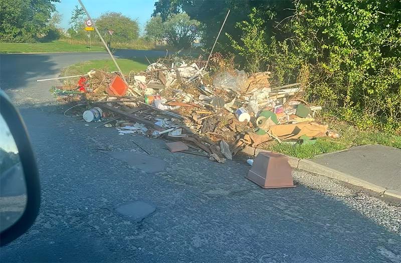 fly tipped rubbish on the side of a road in cambridge