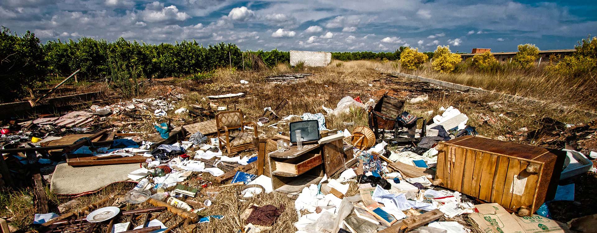 extensive collection of fly tipped rubbish in a field